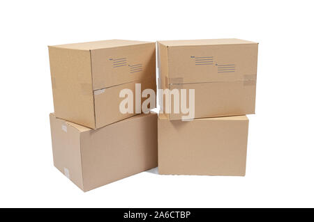 Horizontal shot of four blank cardboard boxes packed for shipping.  Isolated on white. Stock Photo