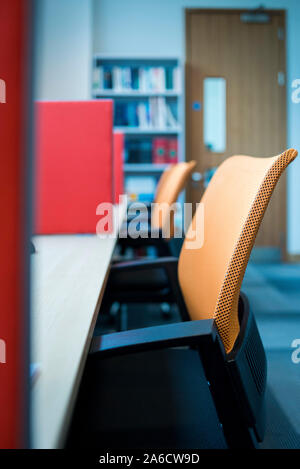 Office chairs and desks in a bright modern office Stock Photo