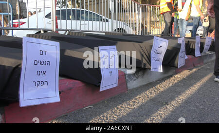 Signs against violence on black coffins in a protest against violence in Arab society and inactivity of police, in front of Northern District police headquarters in Nazareth, Israel, October 22, 2019 Stock Photo