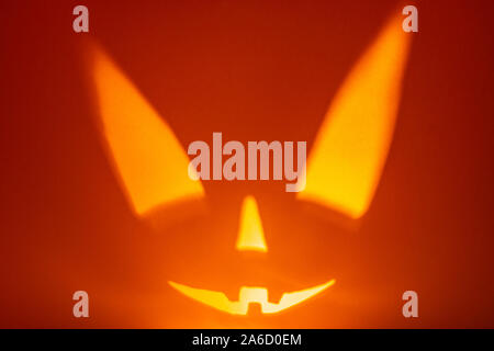 Character halloween scary face on red background. Scary smile face. Holiday horror background. Stock Photo