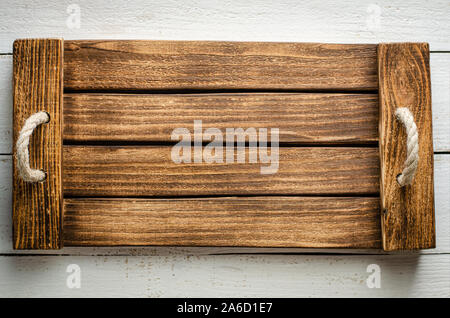 Handmade wooden empty tray on white background. Top view. Stock Photo