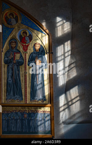 A fragment of the interior of the Church of the Assumption in Vilnius is illuminated by sunlight. Part of a painting depicting Saint Francis of Assisi Stock Photo