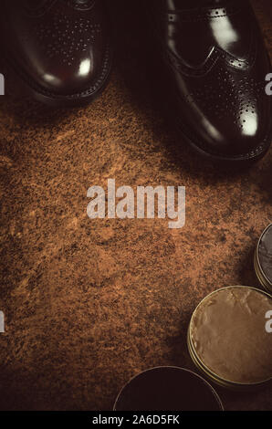 shoe polishing products, still life featuring brushes, polishing paste and leather shoes in a vintage style Stock Photo