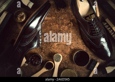 shoe polishing products, still life featuring brushes, polishing paste and leather shoes in a vintage style Stock Photo