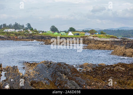 View at the Eagle Point Camping site near Bantry, West Cork, Ireland. Tents and camper vans set up at the banks of Bantry Bay. Camping Holidays. Stock Photo