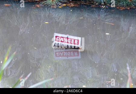DANGER DEEP WATER SIGN IN FLOODED CREEK, SOUTH AUSTRALIA. Stock Photo