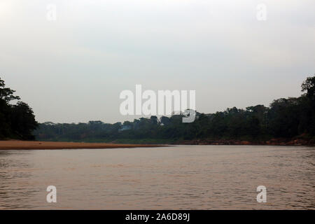 Smoke from a fire in the Amazon rainforest along the Tambopata River in Madre De Dios, Peru at sunrise Stock Photo
