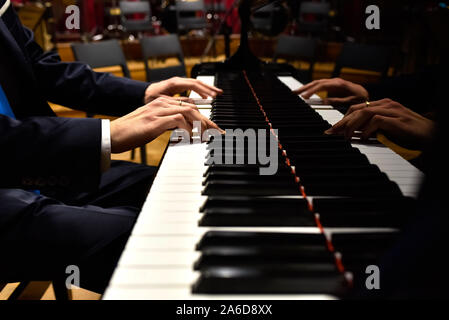 Professional pianist performing a piece on a grand piano. Stock Photo