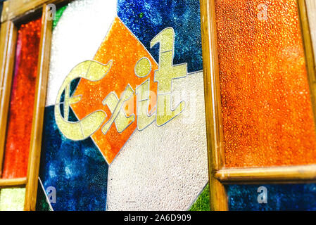 Exit word in an antique engraving on the colorful glass of a door. Stock Photo