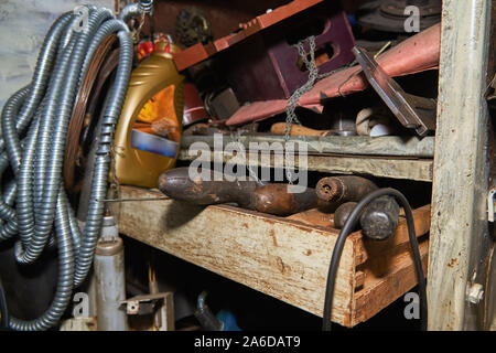 Old instruments on the rack in the old workshop Stock Photo