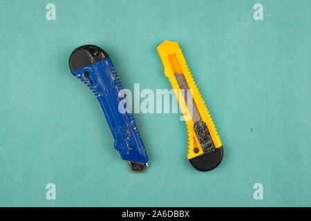 Two office knives on a green background. Suitable for any purprose use. Stock Photo