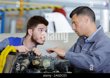 two mechanics working in auto service Stock Photo