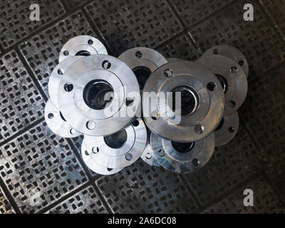 Bellows axial flange compensators. Metal compensators on the factory metal floor Stock Photo