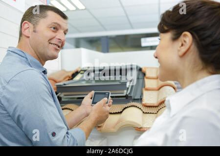 salesman showing rooflight controller to interested client Stock Photo