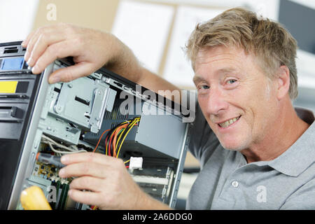 mature man assembling laptop computer Stock Photo