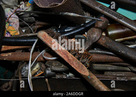 Rusty Metal brush and hammer on the workbench with rusty wrenches made in USSR and other instruments on the background Stock Photo