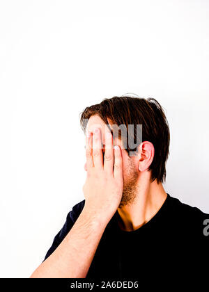 Man Covering Face With Hand in Shame - Side-view Stock Photo