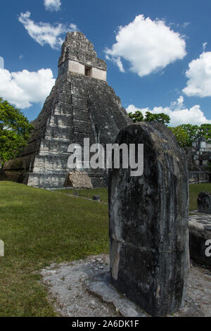 Temple I, or Temple of the Great Jaguar, Tikal National Park, Guatemala.  A UNESCO World Heritage Site.  In front is a carved stone memorial stela. Stock Photo