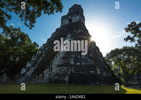 A sunburst or sunstar behind Temple I, or Temple of the Great Jaguar, Tikal National Park, Guatemala.  A UNESCO World Heritage Site. Stock Photo