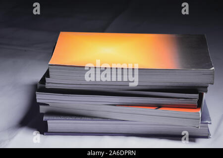Close-up of several colored books stacked on a placed on top selective focus and shallow depth of field. Stock Photo