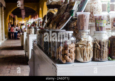 Traditional homemade candies stored in big glass jars are being put for sale, in the famous Portal de los Dulces in Cartagena. Stock Photo