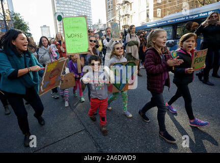 Vancouver, Canada. 25th Oct, 2019. People march along the streets during the climate rally in Vancouver, Canada, Oct. 25, 2019. About 15,000 people march into downtown Vancouver to urge the government to take action in fighting for climate change. Credit: Liang Sen/Xinhua/Alamy Live News Stock Photo