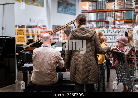 Tigard, Oregon - Oct 25, 2019 : Piano seller and customer at Costco Wholesale store Stock Photo