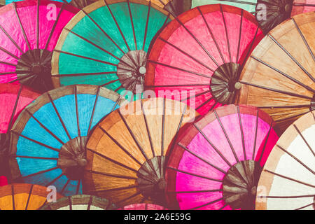 Colorful handmade Asian umbrellas on display at night market in Luang Prabang, Laos.