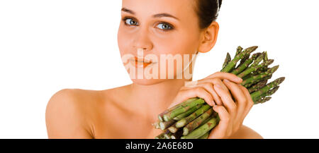 Young woman holding bunch of asparagus. Seasonal food and sustainability. Stock Photo