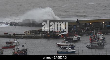 Lyme Regis, Dorset, UK.  26th October 2019. UK Weather: Waves crash over the Cobb and harbour wall on a morning of high winds and heavy rain.  Credit: Celia McMahon/Alamy Live News. Stock Photo