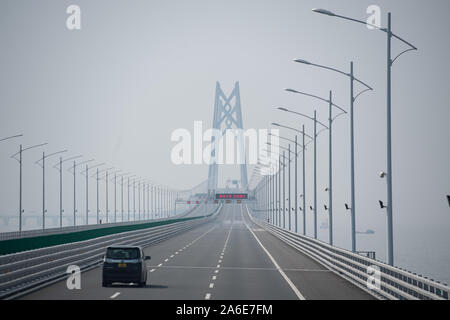 Macao. 24th Oct, 2019. A car heads for the Qingzhou Channel Bridge of the Hong Kong-Zhuhai-Macao Bridge in south China, Oct. 24, 2019. Launched on Oct. 23 last year, the 55-km bridge, known as the longest bridge-and-tunnel sea crossing in the world, links China's Hong Kong Special Administrative Region (SAR), the city of Zhuhai of southern Guangdong Province and Macao SAR, making it more convenient for ordinary people to travel the three places in a single day. Credit: Cheong Kam Ka/Xinhua/Alamy Live News Stock Photo