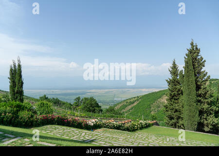 The scenery of Bodbe Monastery, Sighnaghi-St. Nino Monastery with green yard and mountain in Sighnaghi, Stock Photo