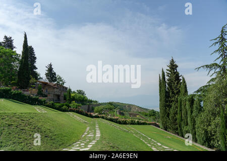 The scenery of Bodbe Monastery, Sighnaghi-St. Nino Monastery with green yard and mountain in Sighnaghi, Stock Photo