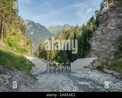 Mudflow protection barrier in a mountain stream in the Alps, in Pfunds, Tyrol, Austria Stock Photo