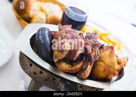 Traditional Argentinian dish asado served at dinner with wine Stock Photo