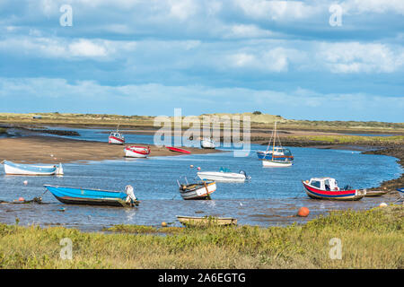 Colourful boats on river Burn estuary at high tide, seen from Norfolk Coast path National Trail near Burnham Overy Staithe, East Anglia, England, UK. Stock Photo