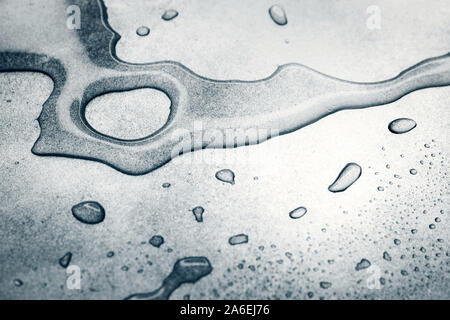 Water drops on rough silvery background, close-up Stock Photo
