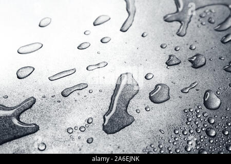 Water drops on rough silvery background, close-up Stock Photo