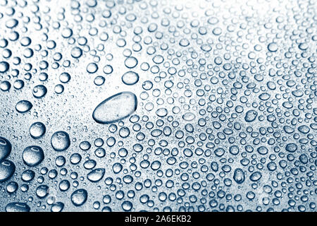 Water drops on rough silvery background, close-up Stock Photo