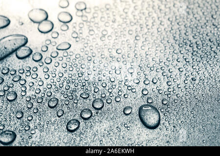 Water drops on rough silvery background, close-up Stock Photo
