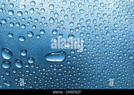 Water drops on rough silvery background, close-up Stock Photo