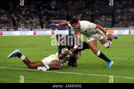 New Zealand's Sevu Reece is tackled by England’s Henry Slade which is then referred to the TMO but escapes any punishment during the 2019 Rugby World Cup Semi Final match at International Stadium Yokohama. Stock Photo