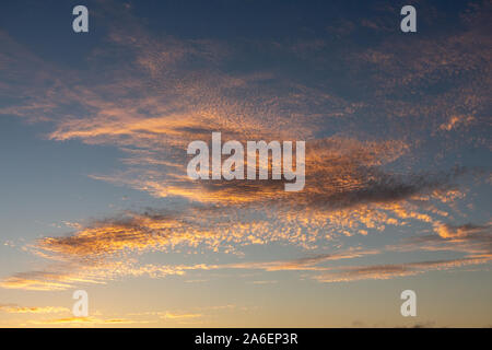 luminous clouds in the evening sky just after sunset Stock Photo
