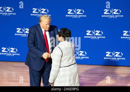 Colombia, United States of America. 25 October, 2019. U.S President Donald Trump former inmate Alice Johnson to the stage, during the 2019 Second Step Criminal Justice Forum at Benedict College October 25, 2019 in Columbia, South Carolina.  Credit: Shealah Craighead/White House Photo/Alamy Live News Stock Photo