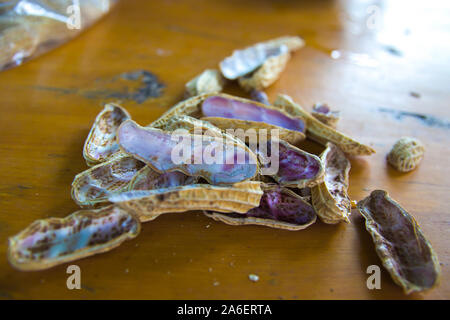 a peel of boiled peanuts on wooden table Thai healthy food peanut corn boil . Stock Photo
