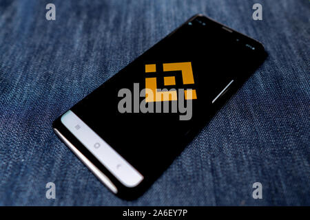 Odessa, Ukraine - October 26, 2019: Binance app. Binance logo visible on smartphone screen. Denim background. Soft focus Stock Photo