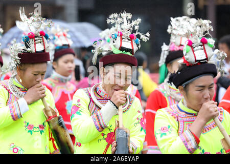 Danzhai, China's Guizhou Province. 26th Oct, 2019. Women of the Miao ethnic group perform a dance with Lusheng, a folk musical instrument made of bamboo pipes, during celebration of the 'Chixin' festival in Danzhai County, Qiandongnan Miao and Dong Autonomous Prefecture, southwest China's Guizhou Province, Oct. 26, 2019. Local residents of the Miao ethnic group were joined by tourists on Saturday in celebrating their traditional 'Chixin' festival for this year's harvest. Credit: Ou Dongqu/Xinhua/Alamy Live News Stock Photo