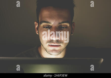 Black runner taking rest drinking energy drink at the beach at summer Stock Photo