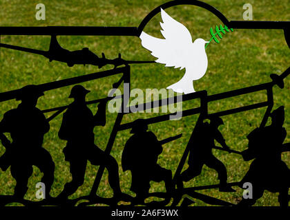 Silhouetted soldiers advancing at the' Battle of the Somme' (1916) and the Dove of Peace, Rochdale Memorial Gardens, Greater Manchester, UK Stock Photo