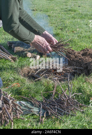 Sequential series of building and lighting survival fire or camp fire. Emergency fire, prepping, survival skills. See additional explanatory NOTES. Stock Photo